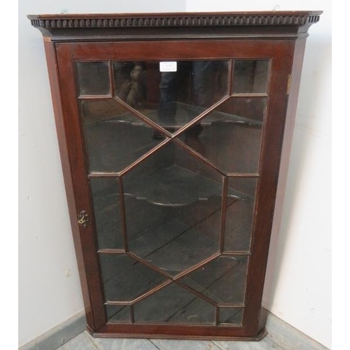 834 - A Georgian mahogany glazed corner cupboard, with dentil cornice, the astral glazed door opening onto... 