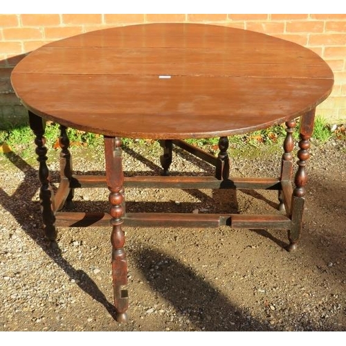 836 - An 18th Century Oak oval drop-leaf gate leg dining table, with single drawer, raised on turned and b... 