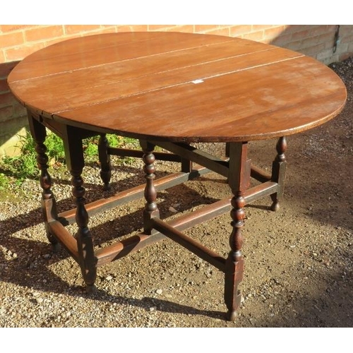 836 - An 18th Century Oak oval drop-leaf gate leg dining table, with single drawer, raised on turned and b... 