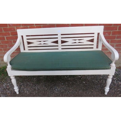 845 - A George III style white painted garden bench, 20th Century, with green squab cushion, 132cm wide.