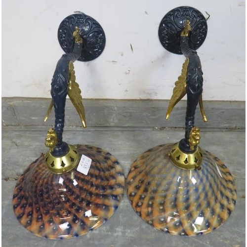 853 - A pair of stylish decorative wall lights, gilded and blue finished cast metal winged serpents beneat... 