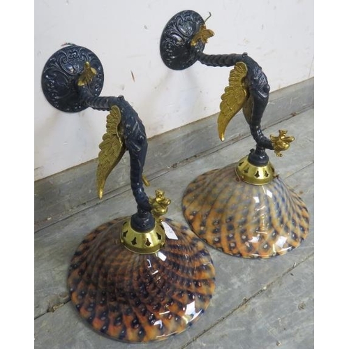 853 - A pair of stylish decorative wall lights, gilded and blue finished cast metal winged serpents beneat... 