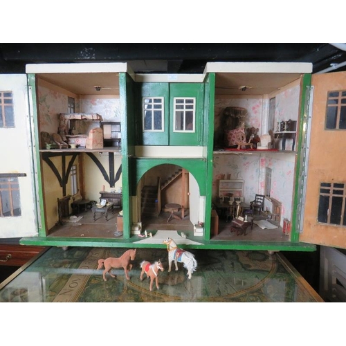 859 - A c.1930's scratch-built Art Deco dolls house, painted green and white. Some old electrics fitted bu... 