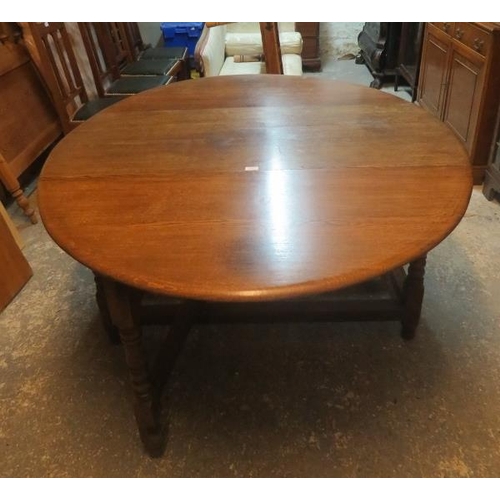 860 - A well made solid oak oval drop leaf gateleg dining table in the 18th century style, raised on turne... 