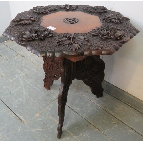 869 - A well-carved early 20th century Anglo Indian octagonal table, the top depicting fruiting vines and ... 