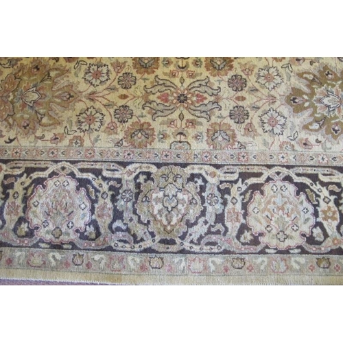 907 - A late 20th century Indian pure wool carpet. Central block pattern of foliage on a deep cream ground... 