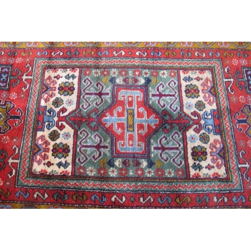 912 - A late 20th century Persian rug with central block panel in good condition. 137cm x 78cm overall.