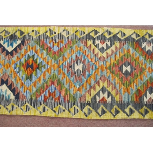 916 - A Chobi Kilim runner, six interlocking diamond motif on a lemon ground. Good condition. 200cm x 57cm... 