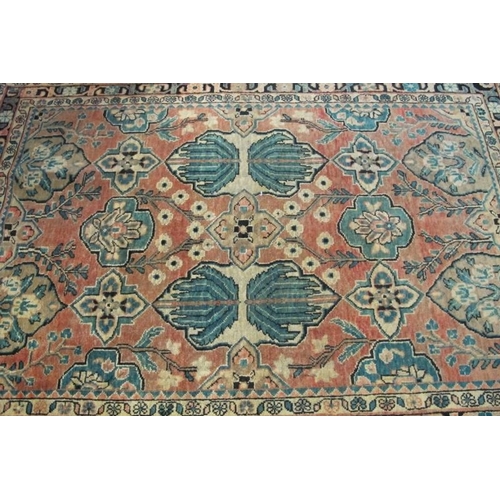 920 - A North West Persian Heriz rug. Central panels depicting flowers/foliage on pale pink ground. 195cm ... 