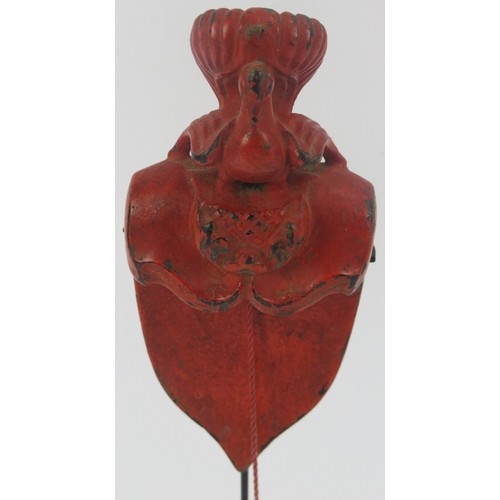 95 - A Southeast Asian red lacquered and carved wood plumb line. Modelled with surmounted bird and cord s... 