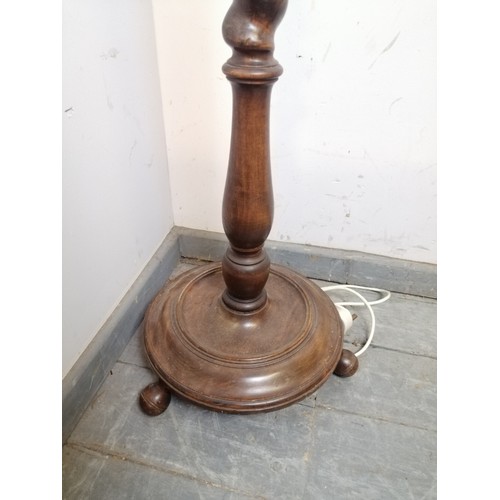 832 - An antique mahogany standard lamp, the tapering barley twist column on a dished circular plinth base... 