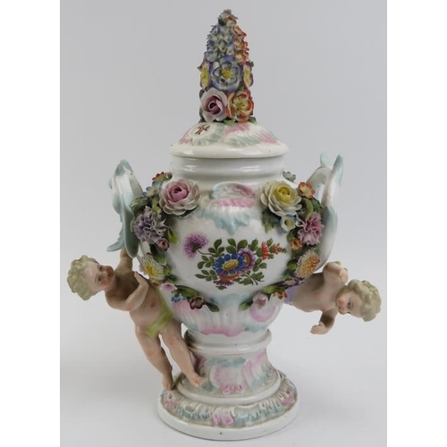 102 - A group of European porcelain wares, 19th century. A large Sitzendorg relief moulded urn and cover i... 