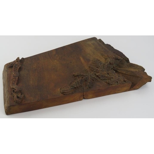 105 - A vintage oak cheeseboard, 20th century. Relief decorated with fruit and foliage, the scroll inscrib... 