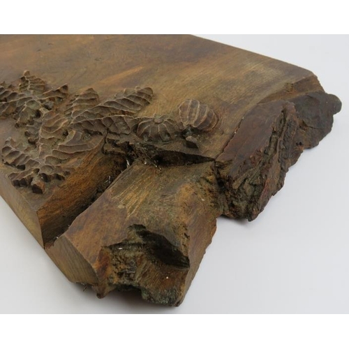 105 - A vintage oak cheeseboard, 20th century. Relief decorated with fruit and foliage, the scroll inscrib... 