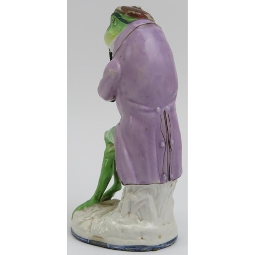 106 - An English hand painted porcelain frog / toad playing a woodwind instrument, mid/late 19th century. ... 