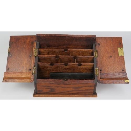 134 - A late Victorian oak stationery letter box. The hinged double doors opening to a reveal tiered lette... 