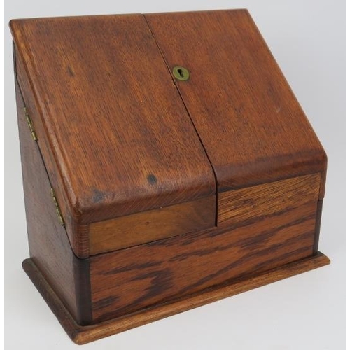 134 - A late Victorian oak stationery letter box. The hinged double doors opening to a reveal tiered lette... 