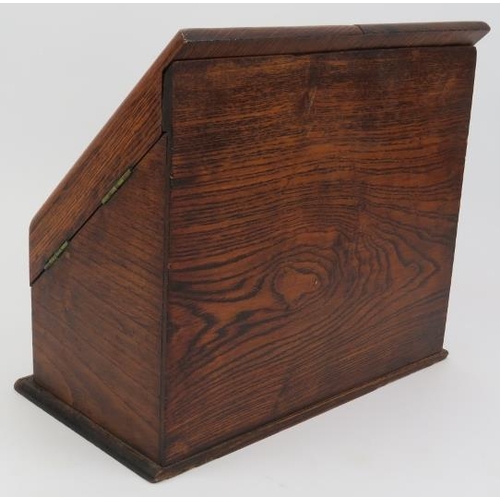 134 - A late Victorian oak stationery letter box. The hinged double doors opening to a reveal tiered lette... 