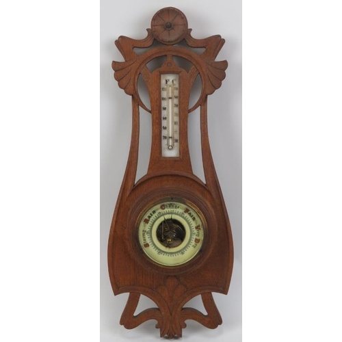 147 - An Art Nouveau carved oak barometer, early 20th century. Incorporated with a mercury thermometer. 48... 