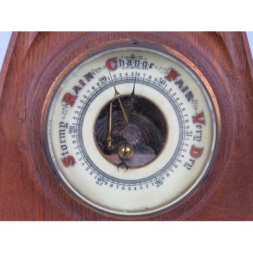 147 - An Art Nouveau carved oak barometer, early 20th century. Incorporated with a mercury thermometer. 48... 