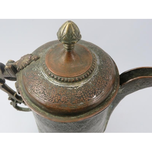 152 - An Indo-Persian metalwork lidded decanter jug with embossed decoration, 19th century. With a hinged ... 