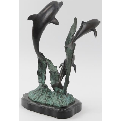 16 - A vintage bronze sculpture depicting dolphins leaping from the water, 20th century. Naturalistically... 