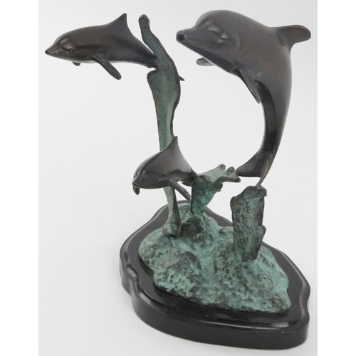 16 - A vintage bronze sculpture depicting dolphins leaping from the water, 20th century. Naturalistically... 