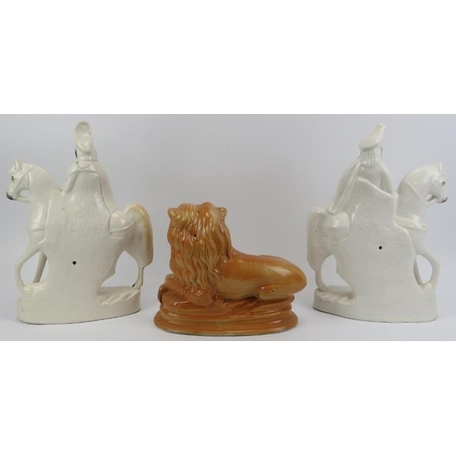 162 - A large pair of Staffordshire ceramic equestrian figures and a recumbent lion. (3 item) Lion: 23.5 c... 