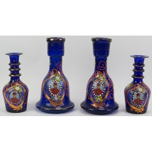 172 - Four Persian gilt enamel painted blue glass bottles, late 19th/early 20th century. Each depicting a ... 