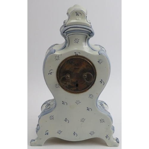 226 - A German Delft ceramic mantle clock. French brass movement. Identical in style to German clocks manu... 