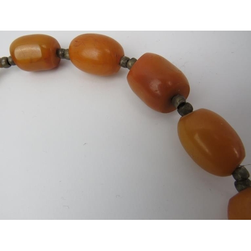 277 - Tribal Art: An African amber beaded necklace. 60 cm approximate length. 
Condition report: Some age ... 