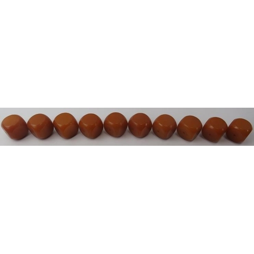 280 - Tribal Art: A group of African bakelite amber coloured cube beads. (10 items) 3.2 cm approximate len... 