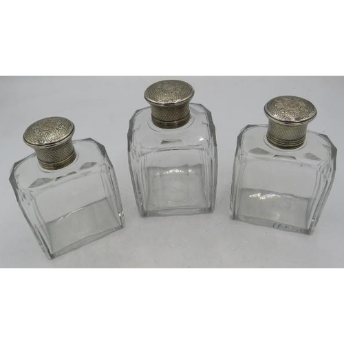 328 - A set of three panel cut glass scent bottles with white metal screw tops and inner stoppers.
Conditi... 