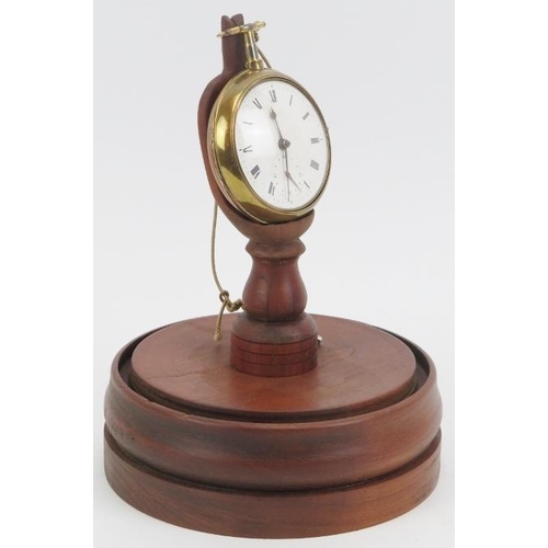 36 - A Georgian pair cased gilt metal pocket watch housed in a domed glass pocket watch stand. With a whi... 