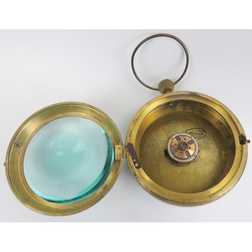 37 - A maritime brass and magnified green glass bullseye ball clock, 20th century. The spherical case wit... 