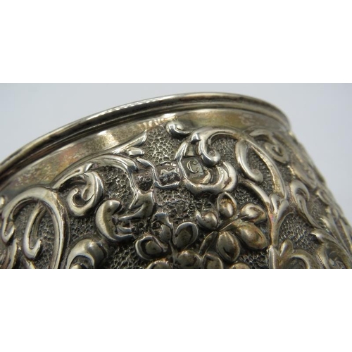 380 - A heavy embossed silver sugar bowl having scrolls & flower decoration, London 1898. Approx weight 5.... 