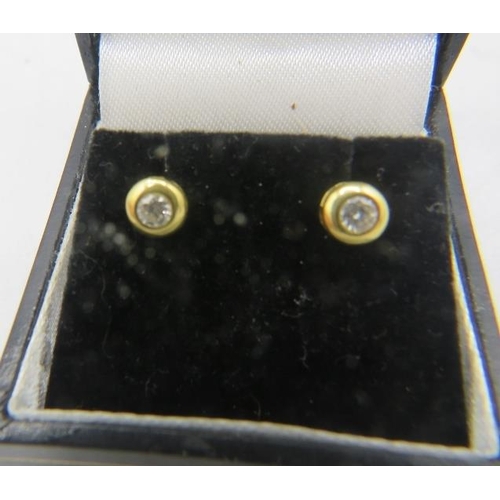 396 - A pair of 18ct yellow gold & diamond stud earrings. Each diamond approx 0.10cts, boxed. Approx weigh... 