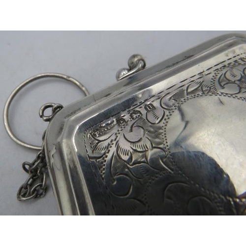 402 - A small silver purse with engraved floral decoration, Birmingham 1919, a chain metal drawstring purs... 