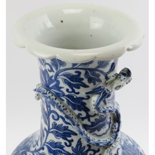 5 - A Chinese blue and white porcelain dragon vase, 19th century. Decorated with a dragon modelled in re... 