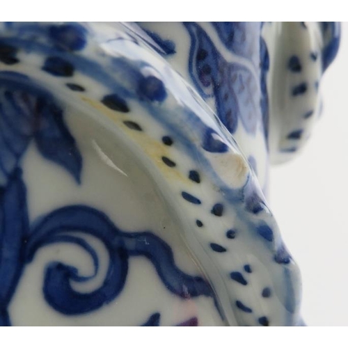 5 - A Chinese blue and white porcelain dragon vase, 19th century. Decorated with a dragon modelled in re... 