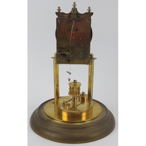 73 - A gilt metal and brass 400 Day Anniversary torsion pendulum clock with glass dome, early 20th centur... 