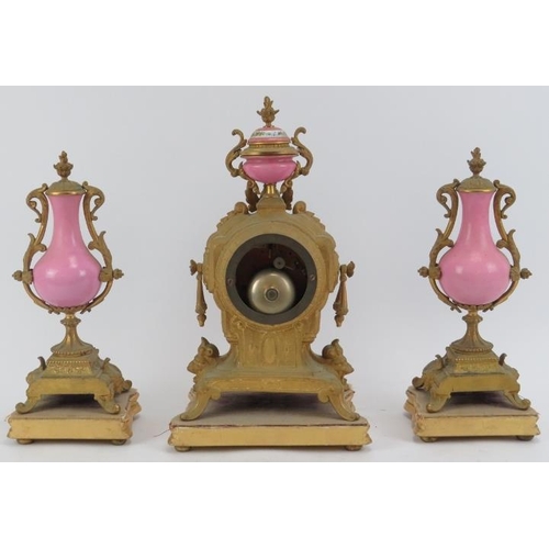 74 - A French gilt brass and painted porcelain mantel clock with matching painted of garnitures, 19th cen... 