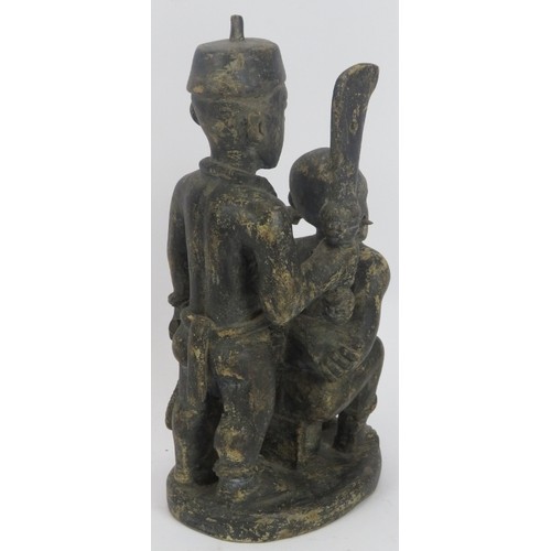 291 - Tribal Art: An African figural carved wood statue, Zaire, Congo. Depicting a male figure being held ... 