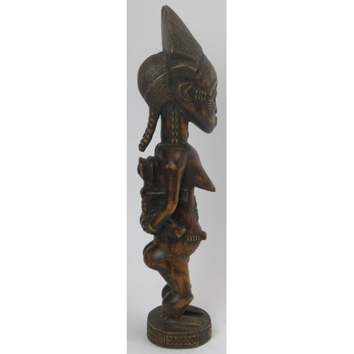 293 - Tribal Art: An African carved wood standing female figure with child, Lulua people, Congo (Zaire). 4... 