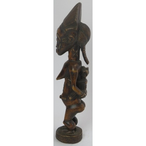 293 - Tribal Art: An African carved wood standing female figure with child, Lulua people, Congo (Zaire). 4... 