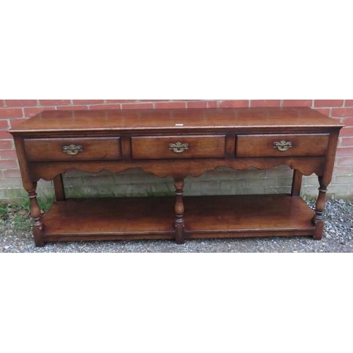 701 - A good quality reproduction oak sideboard in the 18th century taste by Titchmarsh & Goodwin, housing... 