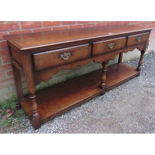 701 - A good quality reproduction oak sideboard in the 18th century taste by Titchmarsh & Goodwin, housing... 