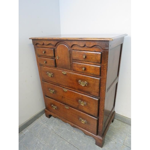 702 - A good quality solid oak chest by Titchmarsh & Goodwin in the 18th century taste, the shaped frieze ... 