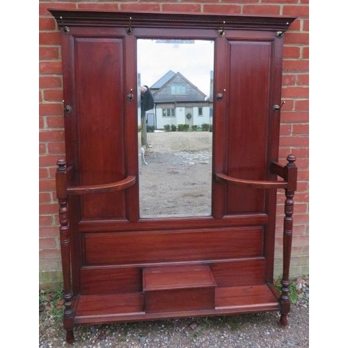 710 - A late Victorian mahogany hall stand of usable proportions, the dentil cornice above a bevelled mirr... 