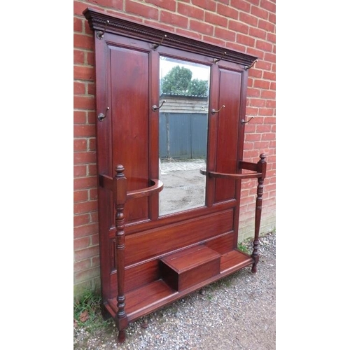 710 - A late Victorian mahogany hall stand of usable proportions, the dentil cornice above a bevelled mirr... 